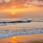 Sunrise on beach with dramatic sky. Marina beach, Chennai, India