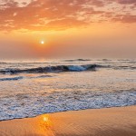 Sunrise on beach with dramatic sky. Marina beach, Chennai, India