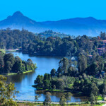 It is about half past seven in the morning in the Hill Station of Kodaikanal, in the South Indian state of Tamil Nadu. The town and the Lake were created by the British during the colonial period. It was created as an alternative for Oothacamandalam, or Ooty as it is popularly known. Perumal Peak can be seen clearly in the distance, to the left of the photo which was shot in the morning sunlight; horizontal format. Copy space