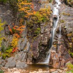 Cascade in the mountains and beautiful autumn colours. Natural background. Silver Cascade, Crawford Notch, NH, USA.
